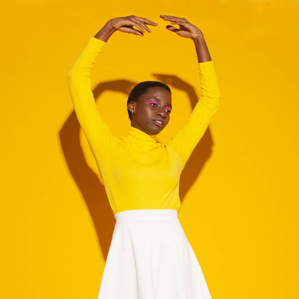 istock black beauty woman isolated on studio yellow background 1476924172
