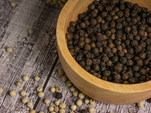 istock The black pepper corn on wood table for food concept 1476924200
