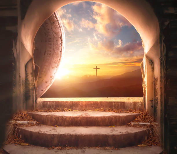 istock Easter and Good Friday concept, Empty tombstone with cross on mountain sunrise background 1476924793