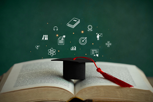 E-learning graduate certificate program concept.graduation hat on the book with education icons. Internet education course degree, Idea of learning online class.Webinar Online Courses. Graduation.