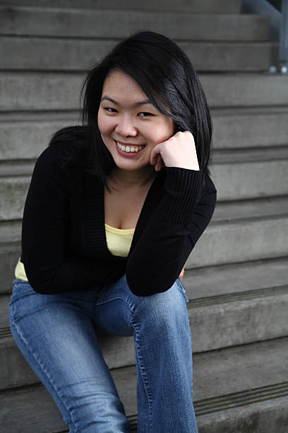 Asian student leaning forward stock photo