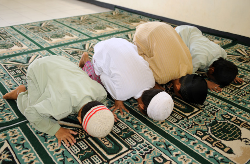 Muslim kids praying at Islamic school
