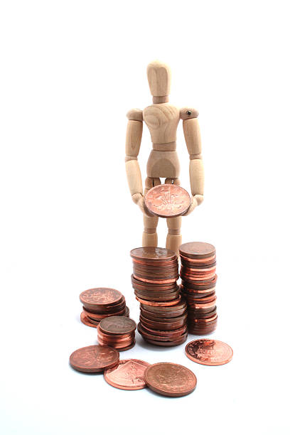 istock Wooden man stacking penny coins on pure white background 147693894