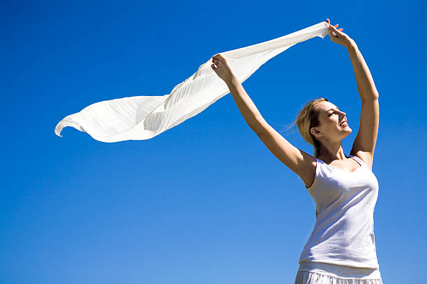 istock Woman holding scarf in wind 147695118