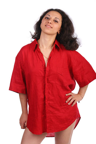 Curly-headed girl in red male shirt posing stock photo
