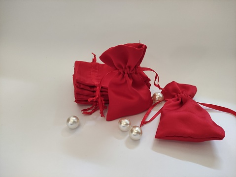 Red pouch over white background. red velvet satin fabric. shiny and elegant