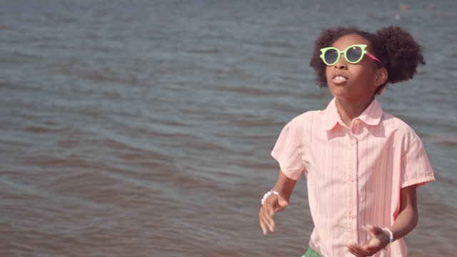 Black Girl Playing with Frisbee at Beach