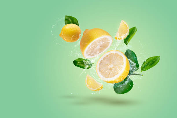 istock Creative layout made form Lemon fruit and lemon slices and water splashing on a green background. 1476961419