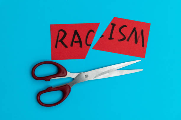 istock Scissor cutting paper with word racism 1476962332