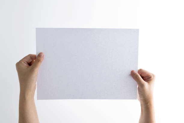 Blank white paper on brown paper background.