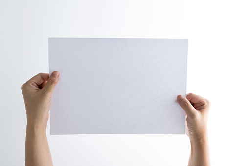 Human hand holding blank paper on white background