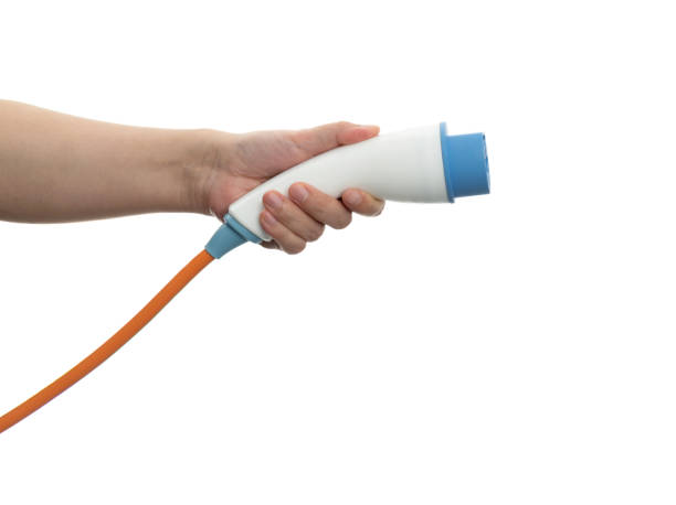 istock Human hand holding electric plug on white background 1476963267