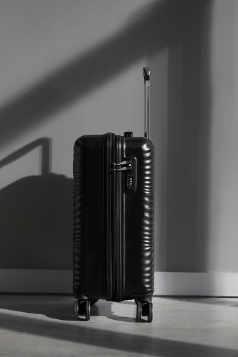 Black Suitcase Over Gray Wall