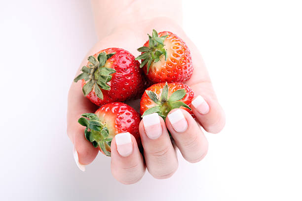 istock Fresh strawberries in hands against white background 147696881