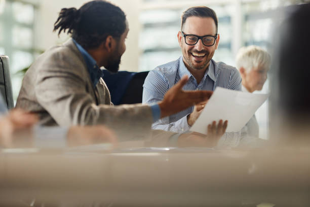 istock Happy male entrepreneurs going through paperwork in the office. 1476970730