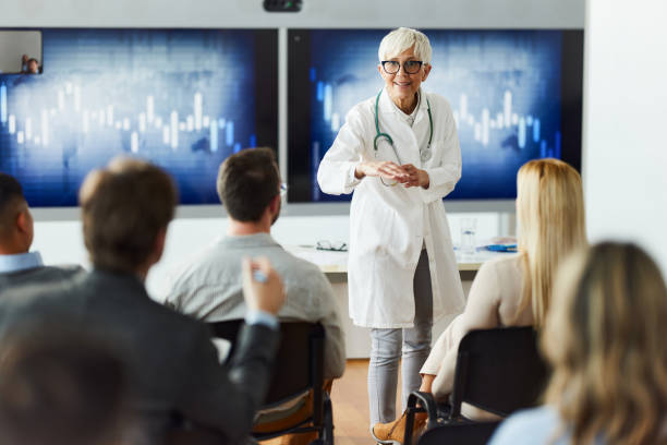 istock Happy senior doctor leading a presentation in board room. 1476971371