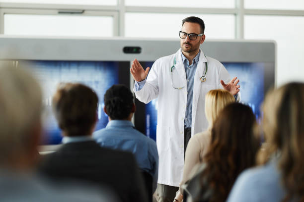 istock Male doctor leading a presentation in board room. 1476972502