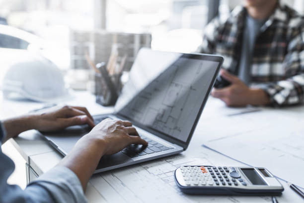 istock Image of engineer meeting for architectural project. working with laptop and engineering tools on workplace 1476973996