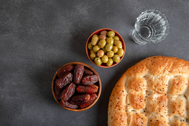 istock Traditional iftar table with dates, pita, green olives,overhead view 1476975756