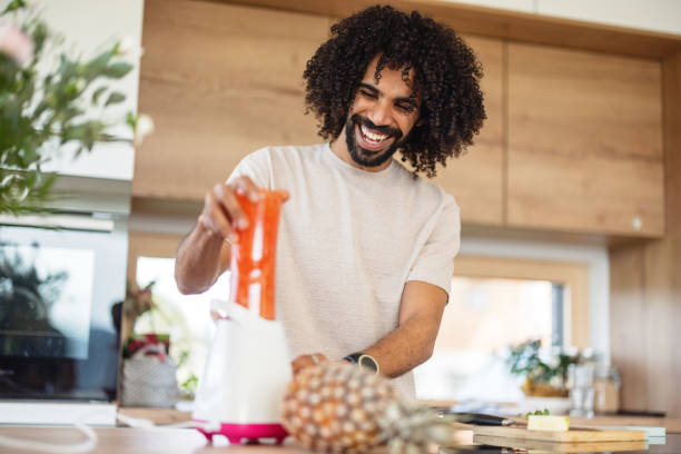 istock Healthy African Man Preparing A Healthy Smoothie For Breakfast 1476976121