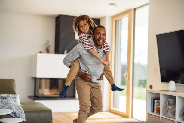 istock Father Carrying His Son On The Shoulders While Laughing 1476976915