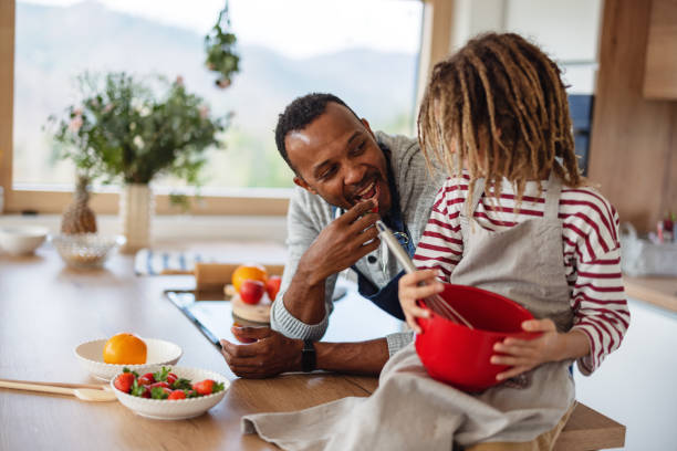 istock Father And Son Cooking Together At Home 1476976929