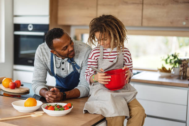 istock Father And Son Cooking Together At Home 1476976964