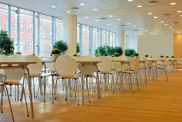 Interior view of a modern Bangkok university library. Empty learning stations stretch across the area.