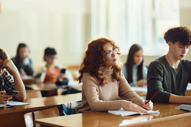 istock Redhead female student paying attention on a class at high school. 1476979239