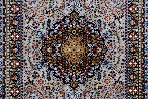 istock Stack of multicolored quality rugs at carpet shop, Carpets variety selection rolled up rugs shop store. 1476981711