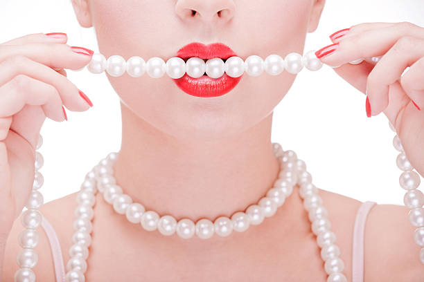Girl holding pearl necklace in hands
