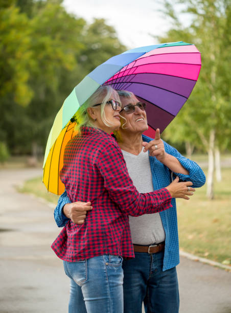 istock Couple walking in wet day 1476983775