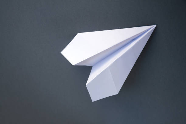 istock White paper plane origami isolated on a grey background 1476985553