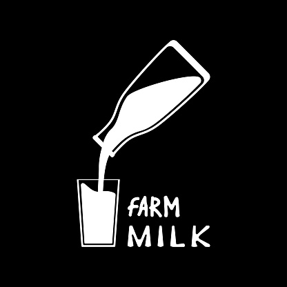 A bottle of milk fills a glass. Farm milk.