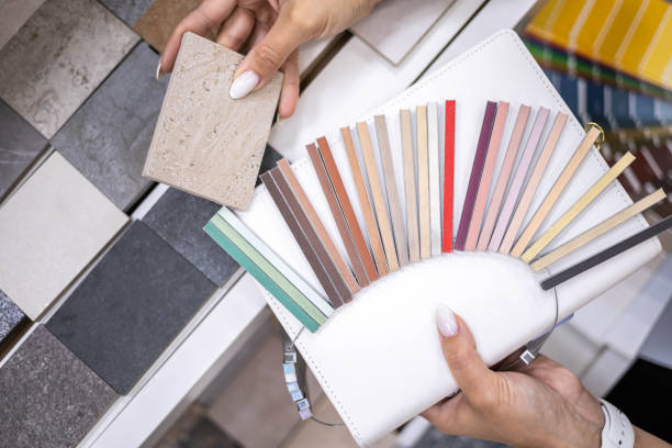 istock Woman architect designer select epoxy grout ceramic tiles compare samples finishing works concept 1476985825