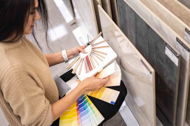 istock Woman architect designer select epoxy grout ceramic tiles compare samples finishing works concept 1476985901