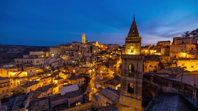 TIME LAPSE shot of ancient Sassi di Matera against sky. Day to Night Time Lapse