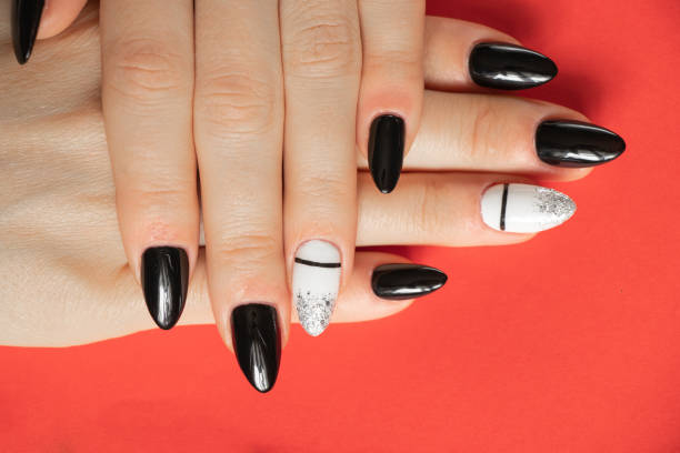 istock extended nails with black and white manicure on a red background, manicure 1476989807