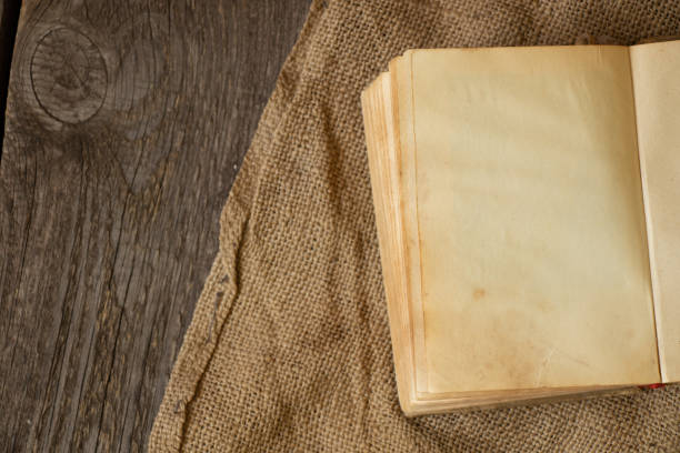 istock old book on an old wooden table close-up 1476990321