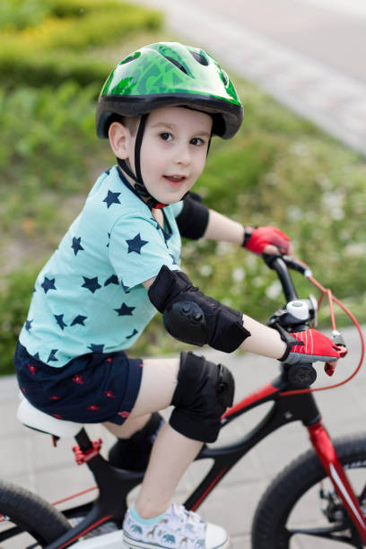 istock Boy in helmet with bicycle outdoor 1476990459