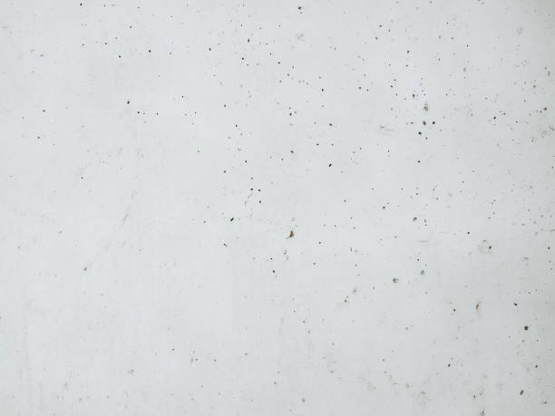 istock White grunge background, a texture of an old concrete surface. Weathered plaster wall with damages. 1476992305