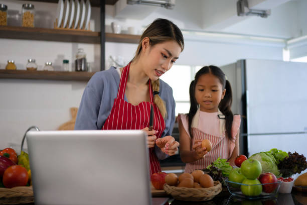 istock Mother and daughter make a meal at kitchen. 1476993321
