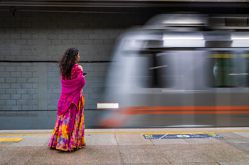 Young Indian woman waiting for a train at subway station, India
