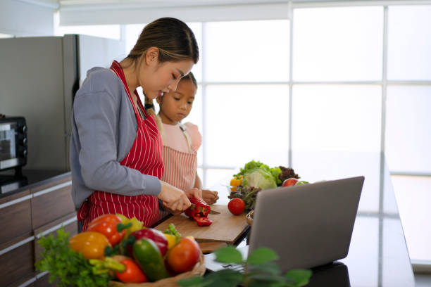 istock Mother and daughter make a meal at kitchen. 1476993377