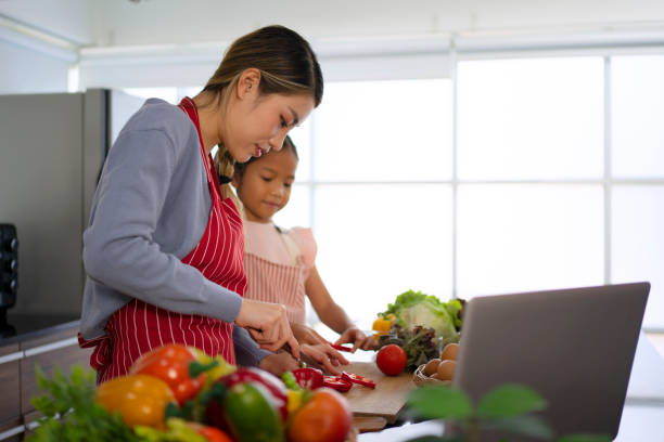 istock Mother and daughter make a meal at kitchen. 1476993417