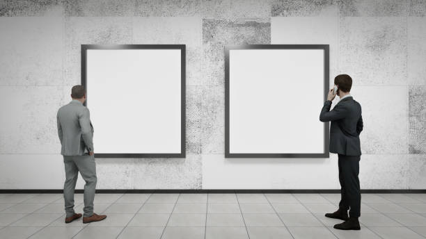 istock Two young businessmen looking at billboards inside a subway station. 3d illustration 1476994308