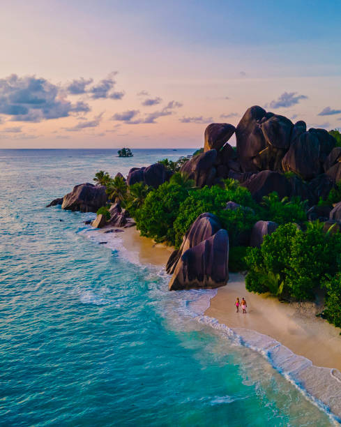 istock Anse Source d'Argent beach, La Digue Island, Seyshelles, Drone aerial view of La Digue Seychelles bird eye view, couple men and woman walking at the beach during sunset at a luxury vacation 1476994699