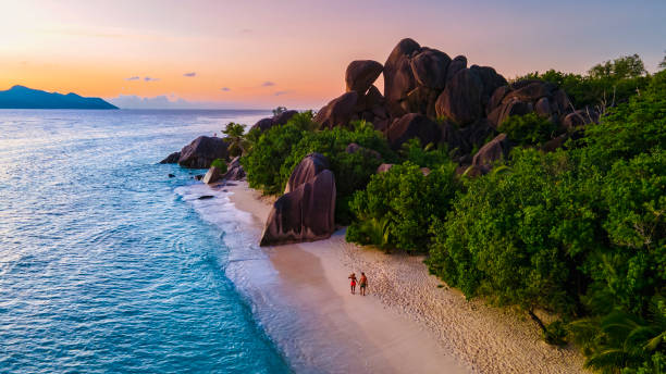 istock Anse Source d'Argent beach, La Digue Island, Seyshelles, Drone aerial view of La Digue Seychelles bird eye view, couple men and woman walking at the beach during sunset at a luxury vacation 1476996839
