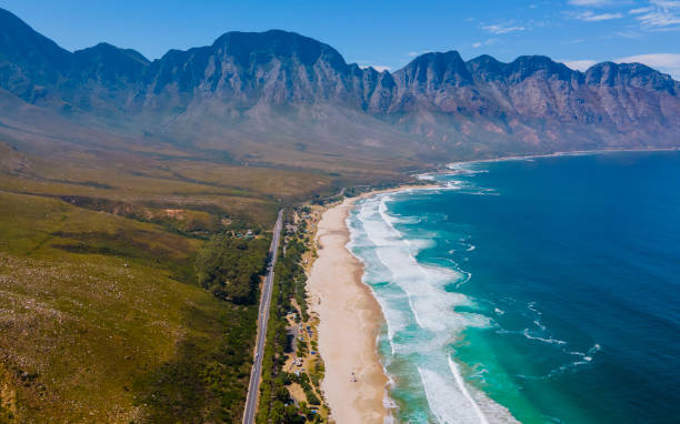 Kogelbay beach Western Cape South Africa, Kogelbay Rugged Coast Line with spectacular mountains Kogelbay beach Western Cape South Africa, Kogelbay Rugged Coast Line with spectacular mountains. Garden route, drone aerial view at the road and beach gordons bay stock pictures, royalty-free photos & images