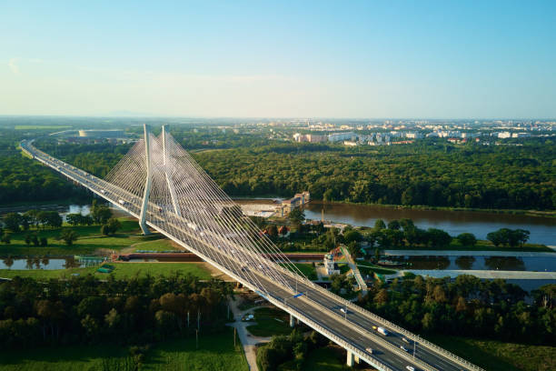 istock Large cable stayed bridge over river with car traffic, aerial view 1477001380